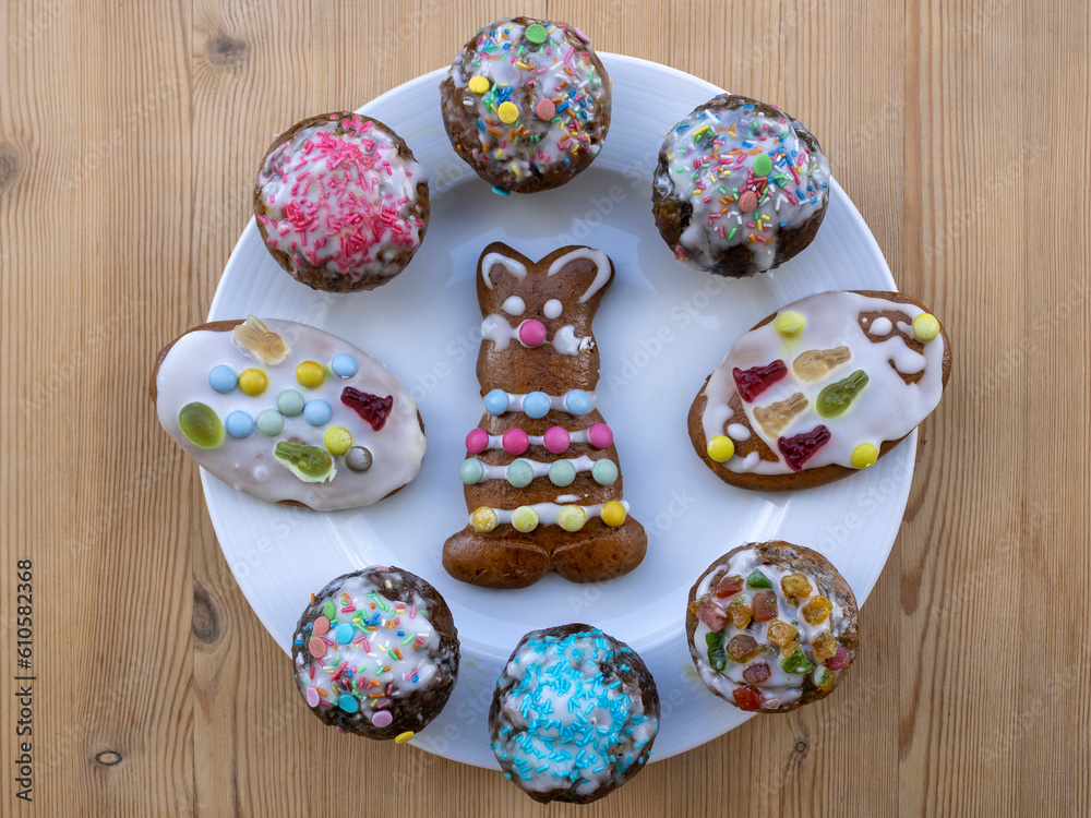 Plate of decorated homemade Easter cupcakes and cookies, top view