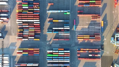 Container port cargo vessel in export import business logistics. Loading by crane in habour and sea transport international aerial top view by drone photo