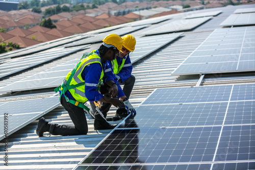 Wallpaper Mural professional technician or engineer installing solar panels, Alternative energy for installed solar panels in use on roof of home Torontodigital.ca