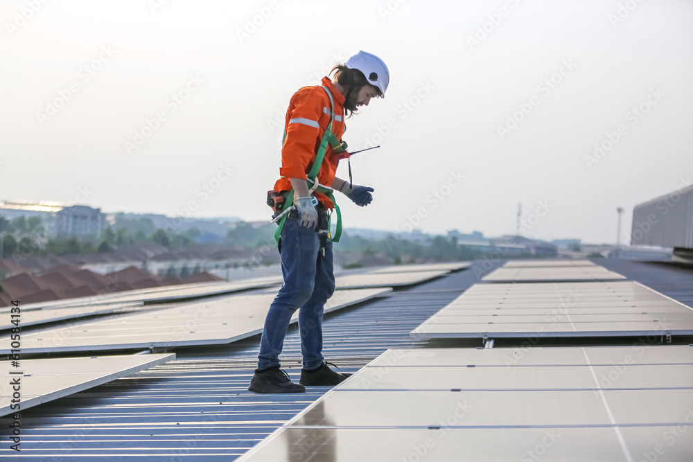 professional technician or engineer installing solar panels, Alternative energy for installed solar panels in use on roof of home