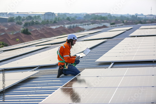 professional technician or engineer installing solar panels, Alternative energy for installed solar panels in use on roof of home