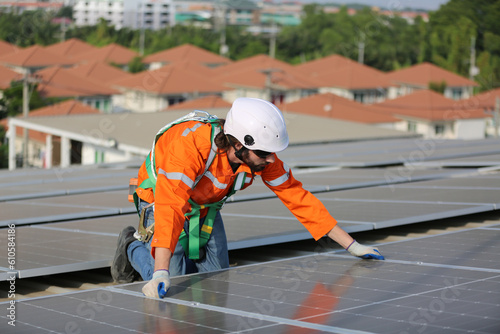 Wallpaper Mural professional technician or engineer installing solar panels, Alternative energy for installed solar panels in use on roof of home Torontodigital.ca