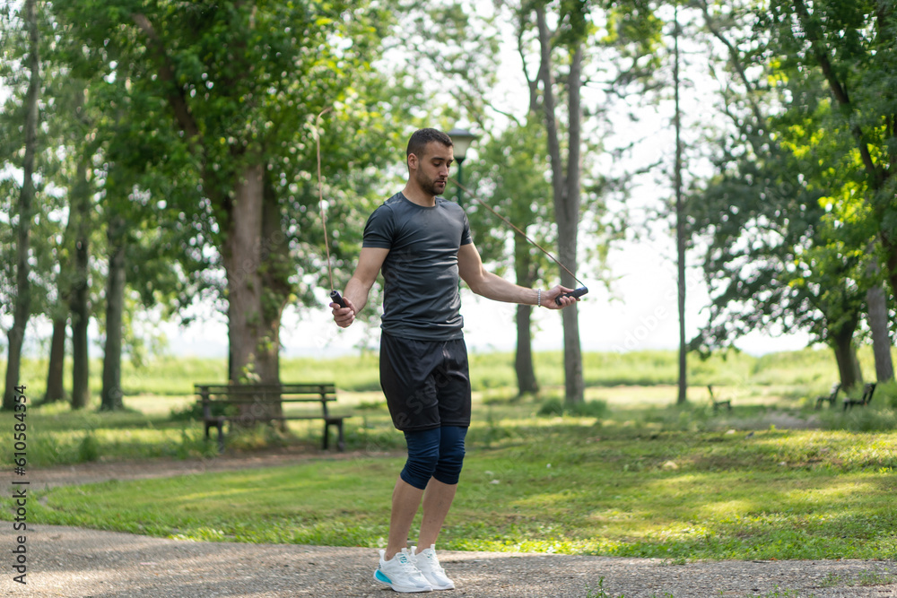 Young man training with a jumping rope outdoor.
Young man training with a jumping rope outdoor.