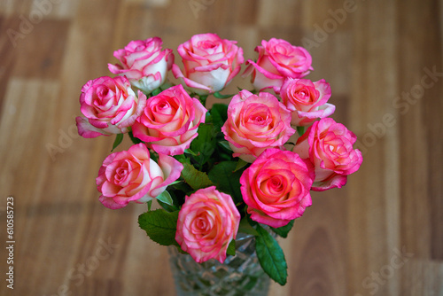 Bouquet of rose flowers on brown blurred background, horizontal orientation