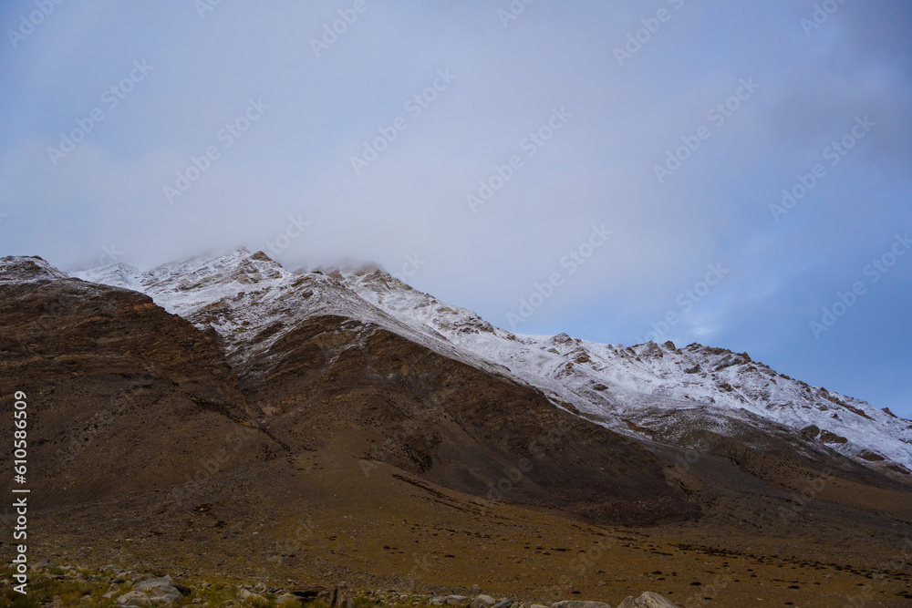 snow covered mountains, cloudy sky at the way from Moriri lake to Leh city, Ladakh, India