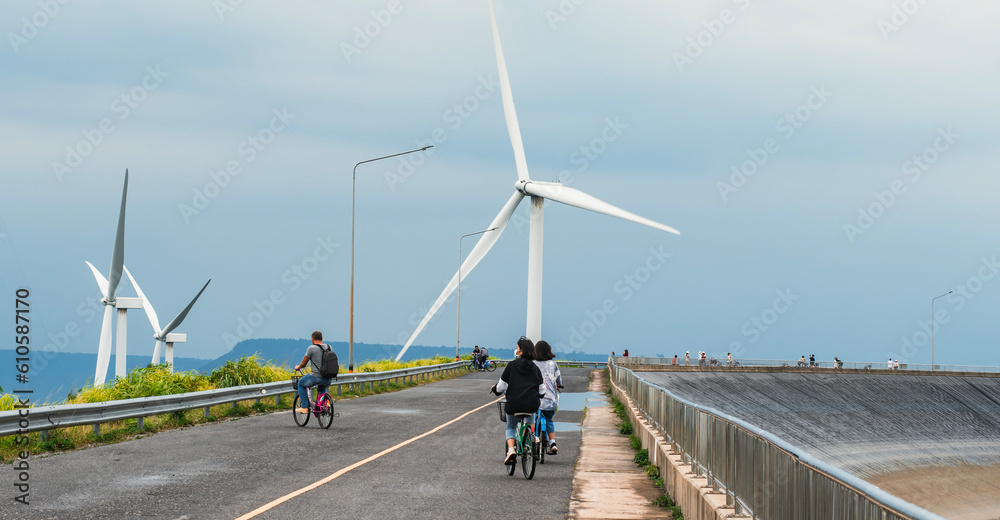 natural energy wind turbines young boys share bicycles to see the scenery