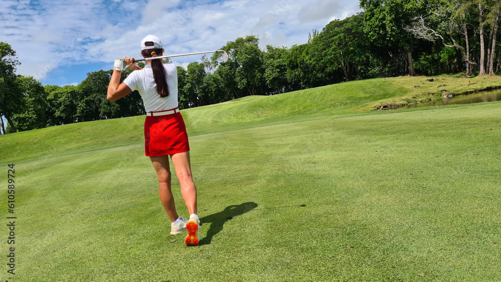 Woman golf player plays golf on golf course Woman golf player plays golf on golf course