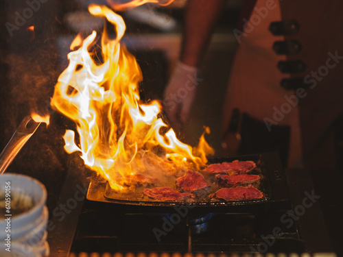 Chef cooking meat on barbecue at a celebration