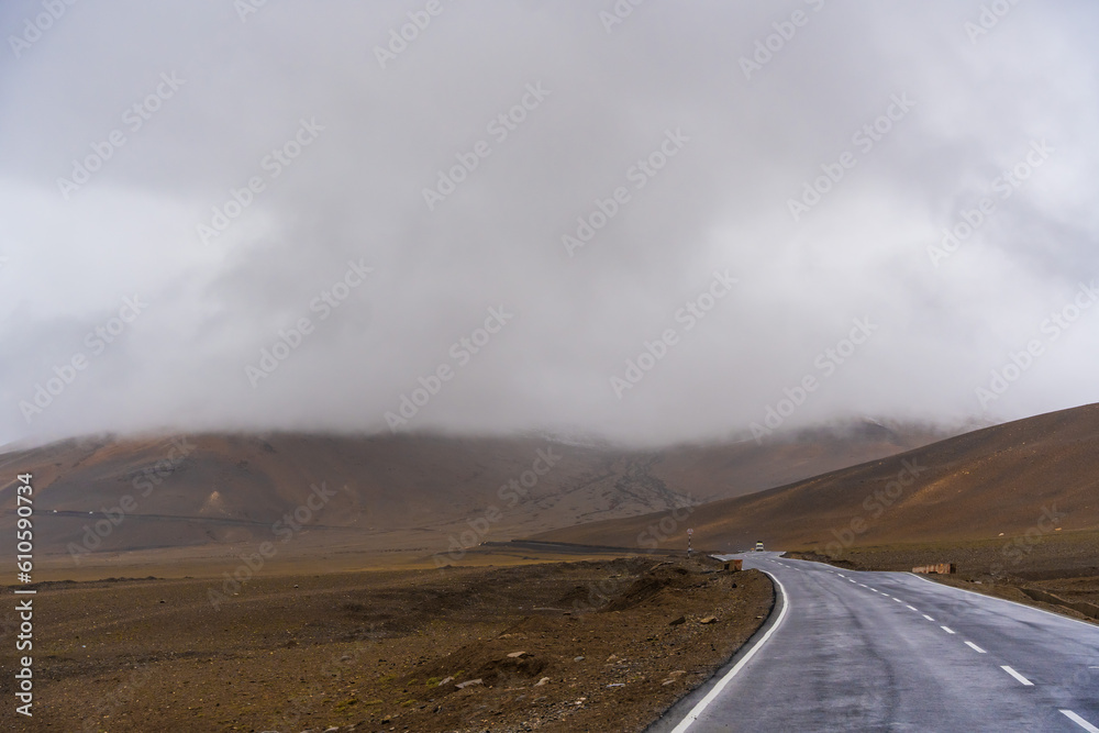  the road, mountain and cloud sky at Tanglang La pass in Ladakh, India, is the second highest motorable road in the world at 5400m