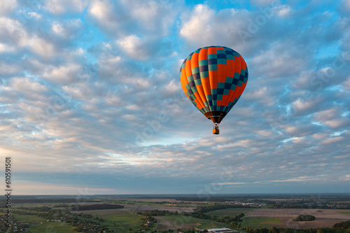 Hot air balloon in blue sky at sunrise © Antonio