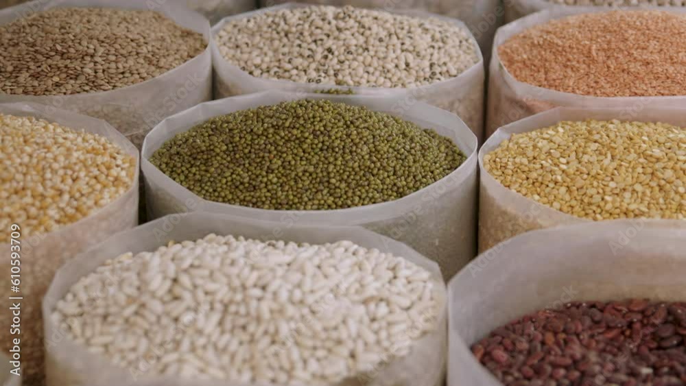 A close-up view of a market stall selling pulses, spices and legumes. A close-up view of a market stall selling pulses, spices and legumes.