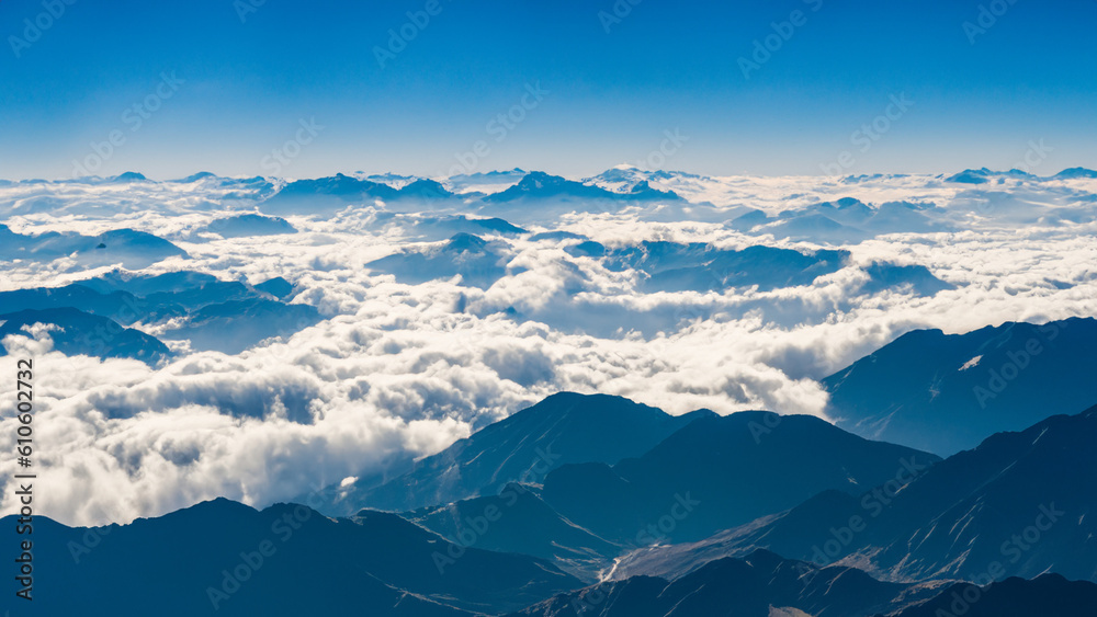 Fototapeta premium The Splendor of the Mountains Flying Through the Clouds - generative ai