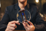 business man's hand is holding magnifying glass and hourglass. Concept of  business deadline time. Finance success. Time management. Planning strategy work with time. Appointment countdown. Schedule.