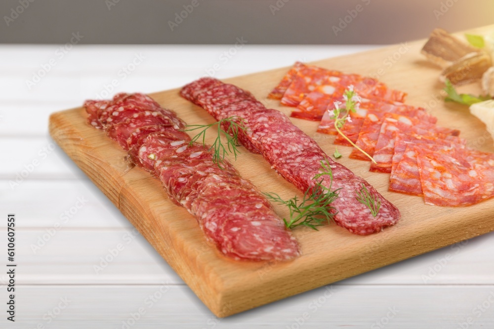 Prosciutto, salami snack on a wooden board. Prosciutto, salami snack on a wooden board.