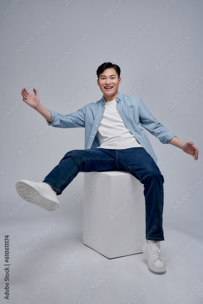 portrait of handsome young man model sitting cube posing in studio portrait of handsome young man model sitting cube posing in studio
