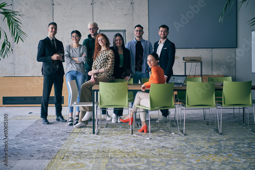 A diverse group of successful businesspeople gather and pose for a photo, showcasing teamwork and professional empowerment in a modern office setting. photo