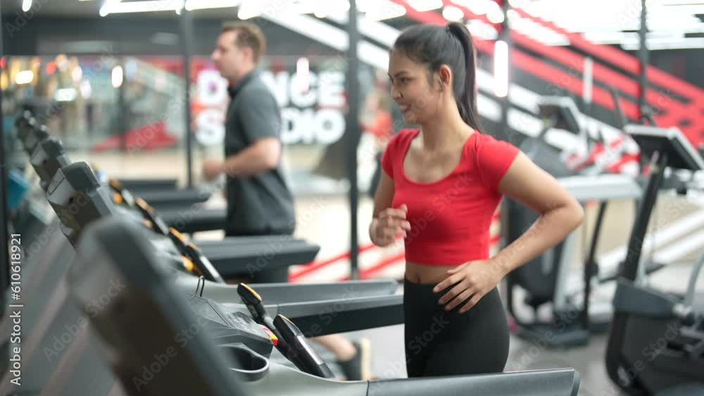 Healthy young Asian woman exercising in fitness gym. Healthy young Asian woman exercising in fitness gym.