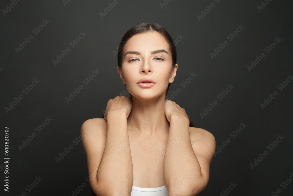Obraz premium Portrait of perfect nice woman with clean shiny fresh skin against black studio wall background