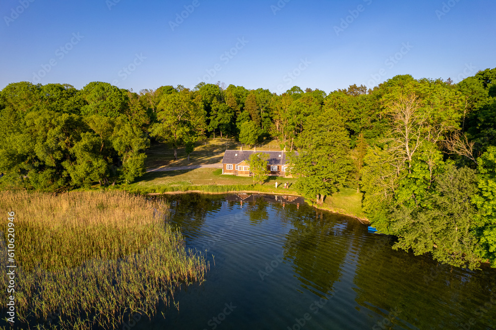 Aerial summer sunny sunset view of old house near Galve lake, Lithuania Aerial summer sunny sunset view of old house near Galve lake, Lithuania