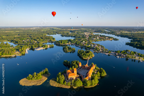 Aerial summer sunny sunset view of Trakai Island Castle and hot air balloons, Lithuania photo