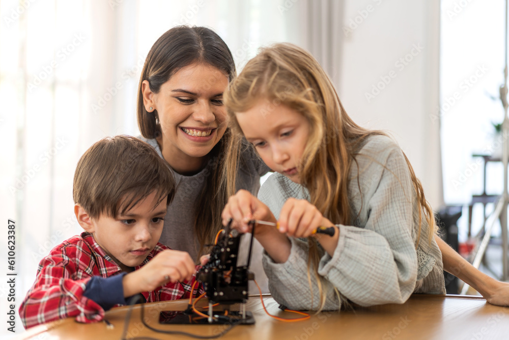 Portrait happy teacher help school children student having fun activity learn training play building toy STEM, education, science, engineering, programming, coding, robot technology class at school Portrait happy teacher help school children student having fun activity learn training play building toy STEM, education, science, engineering, programming, coding, robot technology class at school