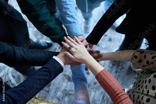 A top view photo of group of businessmen holding hands together to symbolize unity and strength