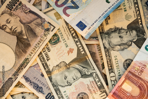 Euro, dollar and yen banknotes stacker. Money concept. photo