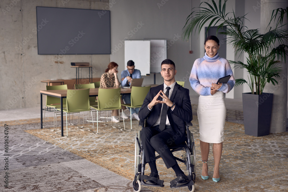 Fototapeta premium A businessman in a wheelchair and his female colleague together in a modern office, representing the power of teamwork, inclusion and support, fostering a dynamic and inclusive work environment.