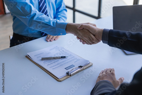 handshake during job interview Male candidate shaking hands with interviewer or employer after job interview Hiring and recruiting in the office