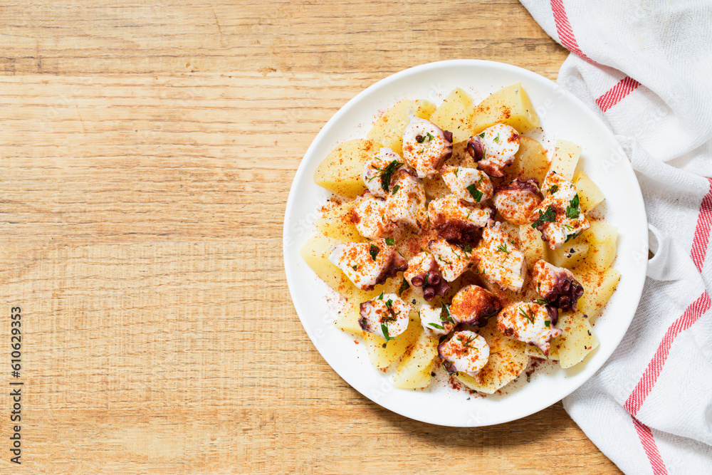 Galician octopus, a traditional Spanish dish with potatoes, octopuses and paprika Galician octopus, a traditional Spanish dish with potatoes, octopuses and paprika
