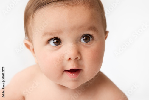 Close-up portrait of smiling brown-eyed infant baby photo