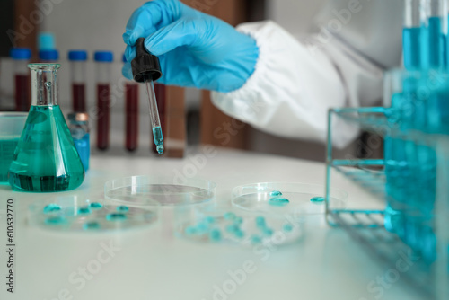 Female scientist researcher conducting an experiment working in the chemical laboratory.