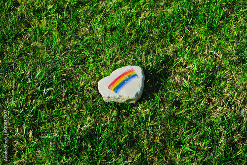 flat rock with a rainbow flag on the grass