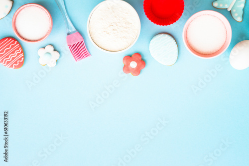 Easter baking, Flour, edds, sugar and gingerbread cookies. Top view on blue. photo