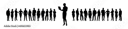 Businesswoman working with laptop while standing in front of large group of business people silhouette.