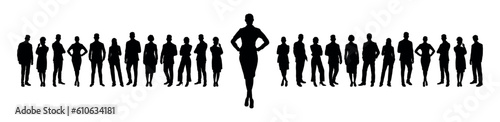 Businesswoman standing with hands on hip in front of large group of business people silhouettes.