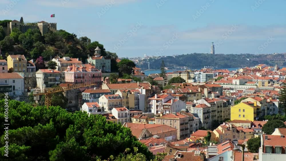 View of Lisbon famous view from Miradouro dos Barros tourist viewpoint over Alfama old city district, 25th of April Bridge and Christ the King statue. Lisbon, Portugal. Camera pan View of Lisbon famous view from Miradouro dos Barros tourist viewpoint over Alfama old city district, 25th of April Bridge and Christ the King statue. Lisbon, Portugal. Camera pan