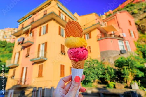 Hand with gelato and view of traditional houses in Manarola, Cinque Terre, Italy © SvetlanaSF