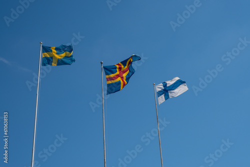 Fags of Sweden, Åland and Finland fluttering against the blue sky