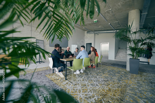 A diverse group of business professionals gathered at a modern office for a productive and inclusive meeting