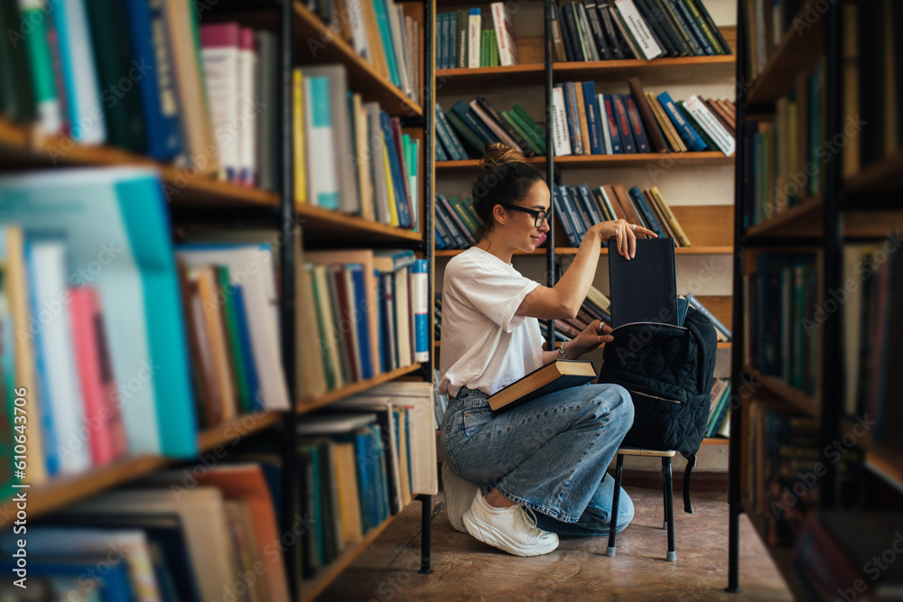 A student stuying and reading books in a public library. A student stuying and reading books in a public library.