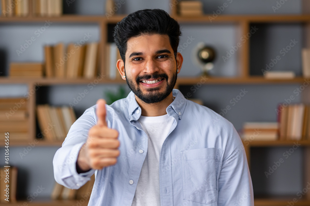 Naklejka premium Young arab handsome man wearing casual clothes doing happy thumbs up gesture with hand. approving expression looking at the camera showing success.