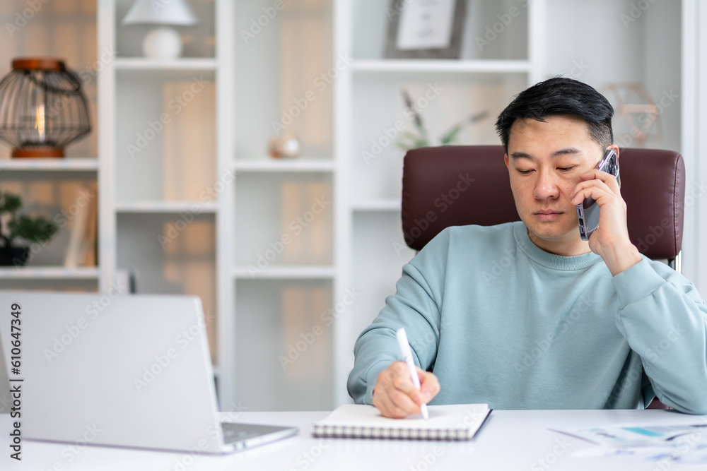 man Taking Notes While Having Phone Conversation Checking Business Or Working Schedule In Notepad, Copy Space