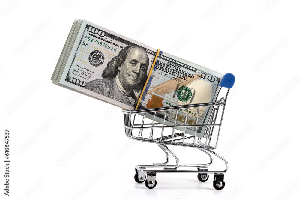 100 american dollar bills and a miniature shopping cart from a supermarket on a white background 100 american dollar bills and a miniature shopping cart from a supermarket on a white background