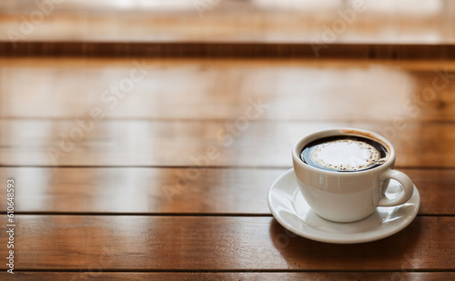 a cup of coffee and coffee beans on the wooden table in the warm cafe beside the window. coffee restaurant concept design mood. Ai illustration generator. top view copy space. wooden floor. close up