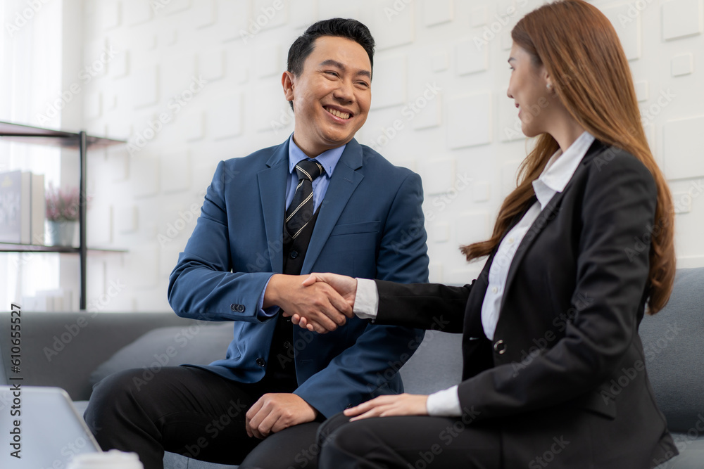Businessman and businesswoman shaking hand for partnership agreement contract success deal at business meeting. Asian businesspeople handshake greeting client manager partner in corporate office. Businessman and businesswoman shaking hand for partnership agreement contract success deal at business meeting. Asian businesspeople handshake greeting client manager partner in corporate office.