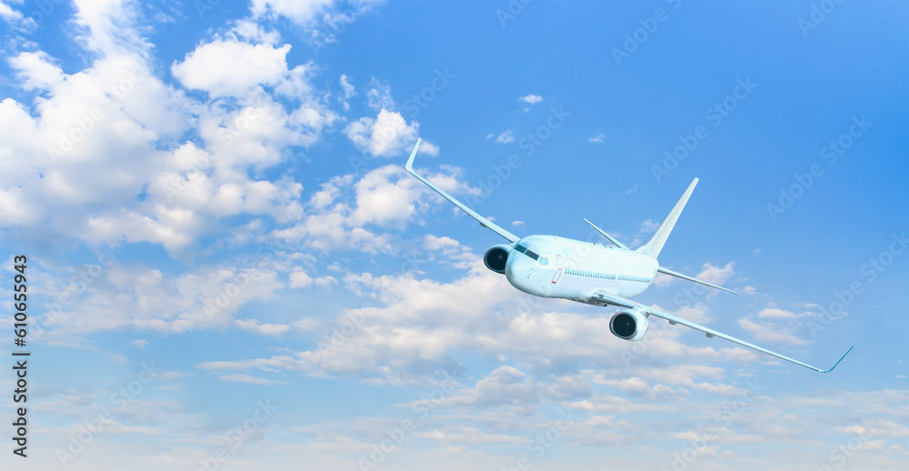 Obraz premium White passenger airplane flying in the sky amazing clouds in the background - Travel by air transport