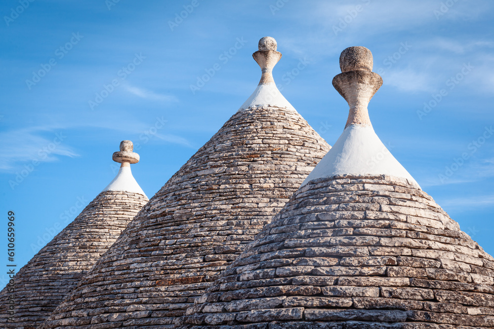 Conical roofs of trulli houses with traditional pinnacles,  Alberobello, Bari, Italy.