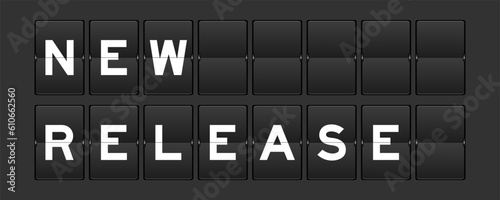 Black color analog flip board with word new release on gray background