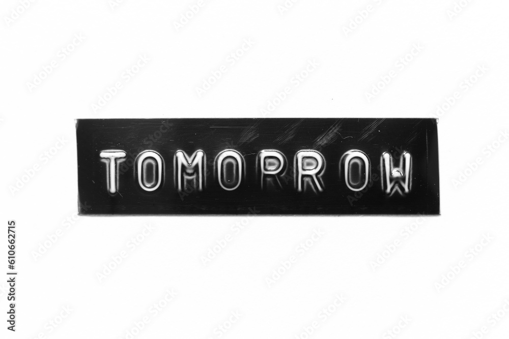 Black color banner that have embossed letter with word tomorrow on white paper background Black color banner that have embossed letter with word tomorrow on white paper background